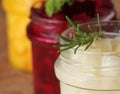 Pickled red, white, orange beet in glass jars. Variety pickles on rustic background