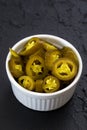 Pickled sliced green jalapeno peppers in white bowl. Close up Royalty Free Stock Photo