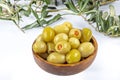 Pickled small green olives, filled with red sweet pepper in a wooden bowl. Fruits of Olea europaea, stuffed with bell pepper Royalty Free Stock Photo