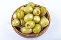 Pickled small green olives, filled with red sweet pepper in a wooden bowl. Fruits of Olea europaea, stuffed with bell pepper Royalty Free Stock Photo