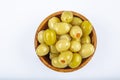Pickled small green olives, filled with red sweet pepper in a wooden bowl. Fruits of Olea europaea, stuffed with bell pepper Royalty Free Stock Photo