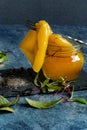 Pickled sweet bell pepper, yellow, in a small glass jar, with spices and beetroot microgreens, a vegetable on a fork in brin