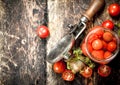 Pickled tomatoes with herbs spices and seamer. Royalty Free Stock Photo