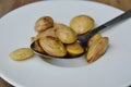 Pickled twisted cluster bean on spoon Royalty Free Stock Photo