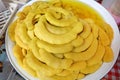 A pickled yellow tamarind in white bowl