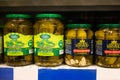 Pickles of cucumbers in banks on the shelves in the store