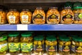 Pickles of vegetables in banks on the shelves in the store