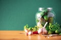 Pickling cucumbers in cans. Ingredients for marinated gherkins, glass jar, garlic, dill, salt, pepper on green Royalty Free Stock Photo