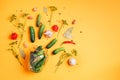 Pickling cucumbers in cans. Ingredients for marinated gherkins, glass jar, garlic, dill, salt, pepper on yellow Royalty Free Stock Photo