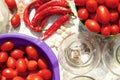 `Pickling vegetables process` canning the tomatoes and chili pepper. Glass jars with tomatoes.