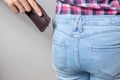 Pickpocketer`s hand pulling stealing wallet out of the back pocket, close up Royalty Free Stock Photo