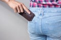 Pickpocketer`s hand pulling stealing wallet out of the back pocket, close up Royalty Free Stock Photo