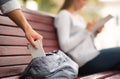 Thief Stealing Cellphone From Girl`s Bag In Park, Cropped Royalty Free Stock Photo