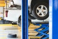 Pickup car raised on car lift in auto service garage center for tire change. Automotive car repairing and maintenance concept