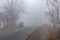 Pickup with cargo load in thick fog over a road