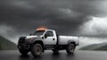 A pickup truck is driving down the road. Dark dramatic landscape as background, gloomy sky with rainy clouds, forest and Royalty Free Stock Photo