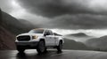 A pickup truck is driving down the road. Dark dramatic landscape as background, gloomy sky with rainy clouds, forest and Royalty Free Stock Photo