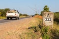 A pickup truck hurrying by A333 milestone kilometre mark along the highway number 9 Ruta Transchaco, Gran Chaco, Paraguay.