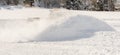 A pickup truck plowing a parking lot