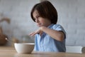 Picky angry eater kid disappointed and disgusted with meal