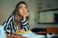 Bored Woman Sitting in a Restaurant Not Eating her Food Royalty Free Stock Photo