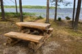Picnic area overlooking a beautiful lake, benches and a wooden table. Royalty Free Stock Photo