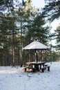 Picnic area with table in the woods in the snow Royalty Free Stock Photo