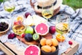 Picnic background with white wine and summer fruits on green grass, summertime party Royalty Free Stock Photo