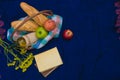 Picnic basket on the blue carpet top view. Books, yellow flowers Royalty Free Stock Photo