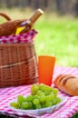 Picnic basket with bottle of wine and food Royalty Free Stock Photo