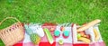 Picnic basket, fruit, juice in small bottles, apples, milk, pineapple summer, rest, plaid, grass Copy space Top view Banner