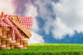 Picnic basket on the grass on the background of the sky .The concept of rest for the weekend or vacation in the spring or summer Royalty Free Stock Photo