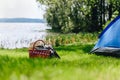 Picnic basket with hat, book and grasses on the grass at the summer sunny day Royalty Free Stock Photo