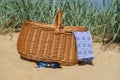 Picnic basket and sunglasses on the beach Royalty Free Stock Photo