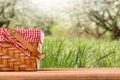 Picnic basket on a table against the background of nature. Rest and summer mood. Departure for a picnic on the weekend or vacation Royalty Free Stock Photo