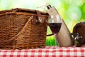 Picnic basket on the table with glass of wine Royalty Free Stock Photo