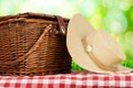 Picnic basket on the table and hat Royalty Free Stock Photo