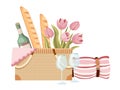 Picnic Basket, Traditional Wicker Box with French Baguettes, Tulip Flowers, Wine Bottle and Glasses with Blanket, Napkin Royalty Free Stock Photo