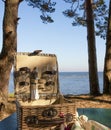 Picnic basket on the wooden table on the beach Royalty Free Stock Photo