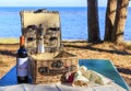 Picnic basket on the wooden table on the beach Royalty Free Stock Photo