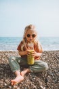 Picnic on the beach child drinking smoothie with glass bottle healthy lifestyle vegan food Royalty Free Stock Photo