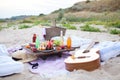 Picnic on the beach at sunset in the style boho, food and drink conception Royalty Free Stock Photo