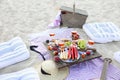 Picnic on the beach at sunset in the style of boho