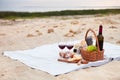 Picnic on the beach at sunset in the white plaid, food and drink