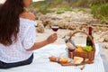 Picnic on the beach at sunset in the white plaid, food and drink Royalty Free Stock Photo