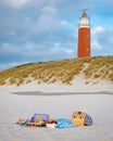 Picnic on the beach Texel Netherlands, Lighthouse of Texel with picnic basket Royalty Free Stock Photo