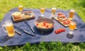 Picnic with beer, roasted sausages, beer snacks, bread and little chorizo sausages