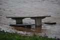 Picnic bench in flood waters Royalty Free Stock Photo