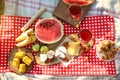 Picnic blanket with delicious food and drinks outdoors on sunny day, flat lay Royalty Free Stock Photo