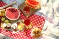 Picnic blanket with delicious food and drinks outdoors on sunny day, flat lay Royalty Free Stock Photo